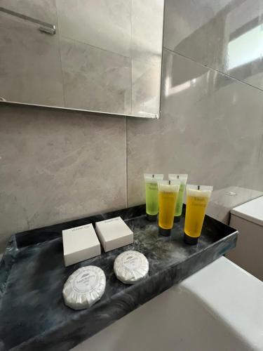 a black tray with three glasses of beer on it at Kalidoniahouses in Perapedhi