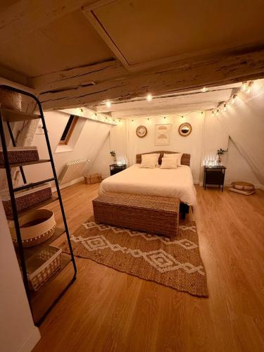 a bedroom with a large bed in a attic at Secret Factory & Spa in Soultz-Haut-Rhin