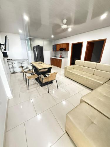 a living room with a couch and a table and chairs at TORRES DEL MESÓN LUXURY APARTA HOTEL Doradal in Doradal
