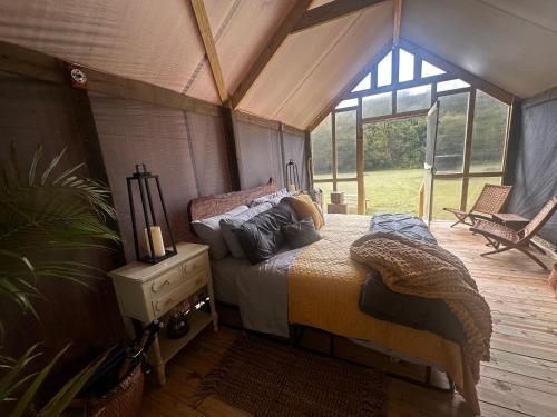 a bedroom with a bed in a tent at Luxury Cozy Glamping Cabin Retreat Natural Hide Out in Sugar Hill