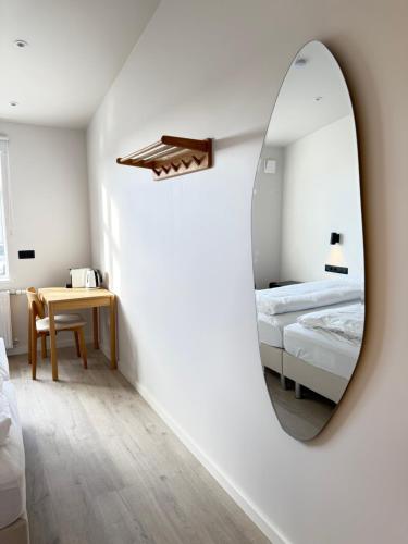 a bedroom with a mirror and a bed and a table at Central Stay Hofn in Höfn