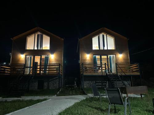 a house with two windows and two chairs at night at Mountain View in Stepantsminda