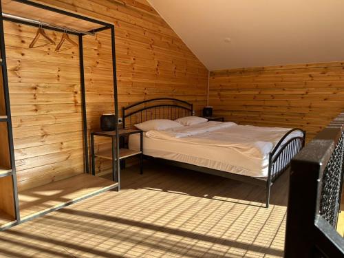 a bedroom with a bed in a wooden room at Mountain View in Stepantsminda