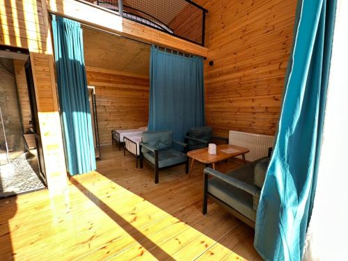 a room with a bed and a couch and a table at Mountain View in Stepantsminda