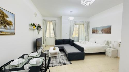 a living room with a couch and a bed at X11 Furnished with balcony England cluster international city near Dragon Mart in Dubai