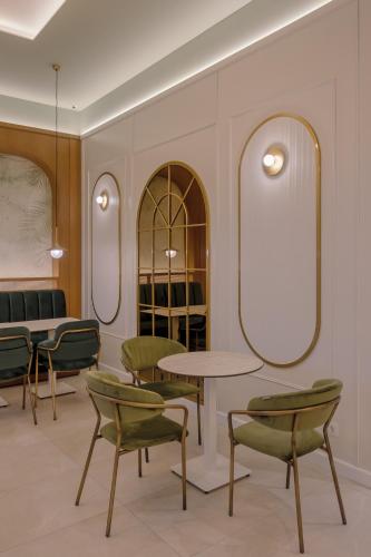 a waiting room with chairs and a table and mirrors at Swan Lake in Ioannina