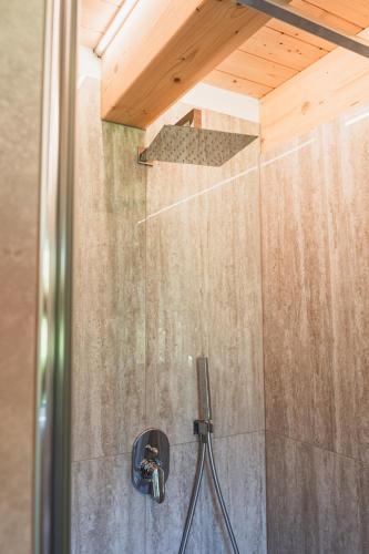 a shower with a wooden ceiling in a bathroom at Casa Stefania 2 in Pieve Di Ledro