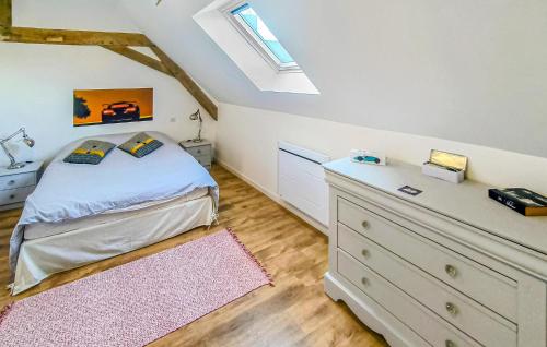 a bedroom with a bed and a dresser and a window at Gite Avec Piscine in Parennes