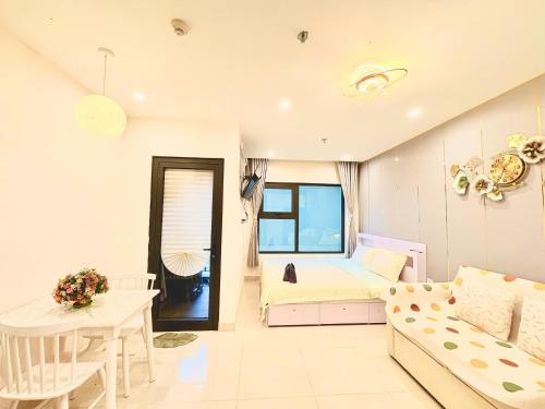 a living room with a bed and a couch at Beautiful Hotel Vinhomes Grand Park - Long Bình in Gò Công