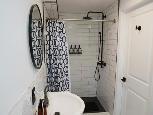 a bathroom with a sink and a shower at 10 Minute walk to Light Rail in Jersey City