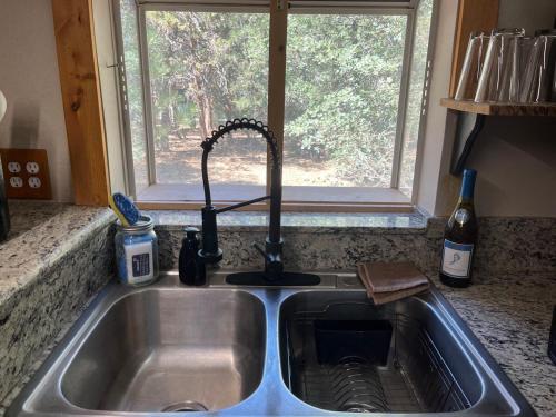 a sink in a kitchen with a window at Sugar Suites Cozy Cabin Retreat Near Big Bear in Sugarloaf