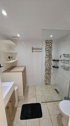 a bathroom with a shower and a sink and a toilet at Bungalow Tauro in Mogán