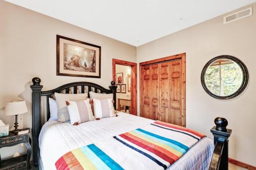 a bedroom with a bed with a colorful striped blanket at Aspen Springs Sundance, Mountain Cabins Utah, 5 BR, 4 BA, Pool Table in Sundance