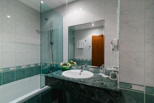 a bathroom with a sink and a mirror at Atlant Hotel in St. St. Constantine and Helena