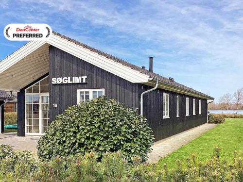 a black building with a sign on the side of it at 10 person holiday home in Ansager-By Traum in Ansager