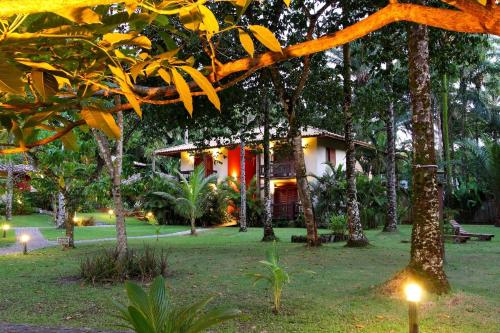 a house in the middle of a park with trees at Aldeia do Mar Sensorial Hotel in Itacaré