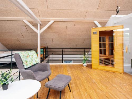 a living room with a table and a chair at 4 star holiday home in Henne in Henne