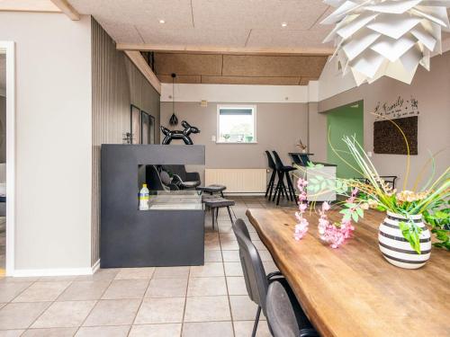 a living room with a table and a dining room at 4 star holiday home in Henne in Henne