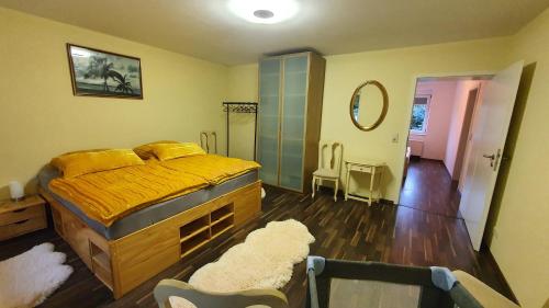 a bedroom with a yellow bed and a mirror at Entspanntes Wohnen Deibow in Deibow