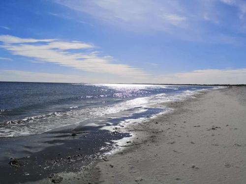 a beach with the ocean on a sunny day at 10 person holiday home in Ålbæk-By Traum in Ålbæk