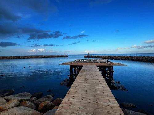 a wooden pier in the water near the ocean at 10 person holiday home in Ålbæk-By Traum in Ålbæk