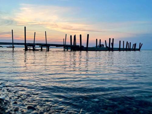 a dock on a body of water at sunset at 10 person holiday home in Roslev-By Traum in Roslev