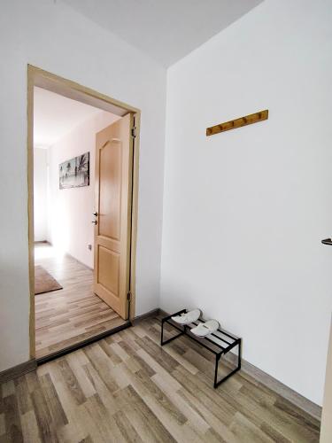 a mirror in a white room with a table and shoes at Pura Vida Downtown Tiny houses in Bucharest