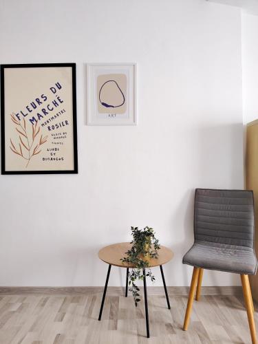 a table and a chair in a room at Pura Vida Downtown Tiny houses in Bucharest