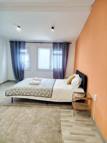 a bedroom with a large bed and a window at Pura Vida Downtown Tiny houses in Bucharest