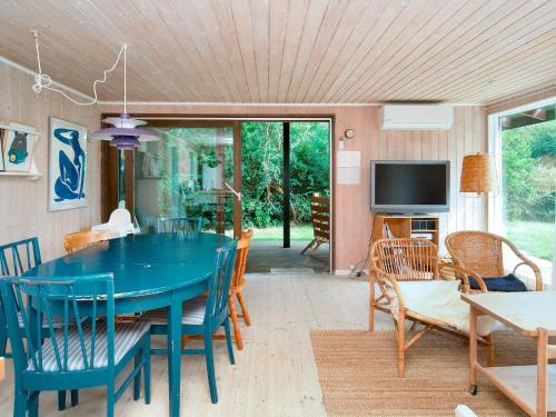 a dining room with a blue table and chairs at 6 person holiday home in Fårevejle-By Traum in Fårevejle