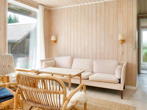 a living room with a couch and a table at 6 person holiday home in Fårevejle-By Traum in Fårevejle