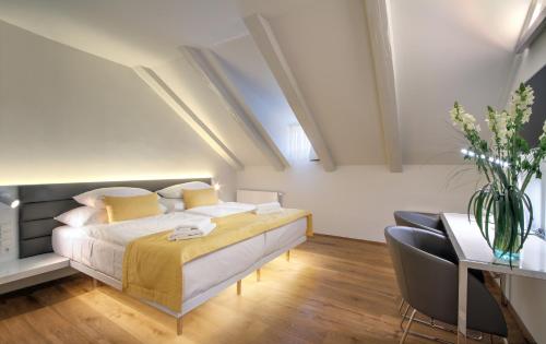 a bedroom with a bed and a table and chairs at Bishop's House in Prague