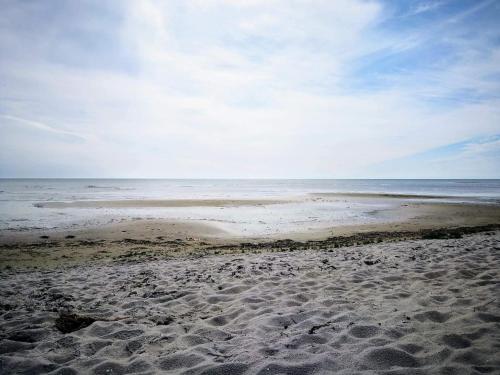 a sandy beach with the ocean in the background at 5 star holiday home in Hadsund in Hadsund
