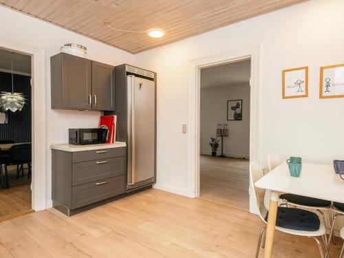 a kitchen with a refrigerator and a table in a room at 4 star holiday home in Nørre Nebel in Nørre Nebel