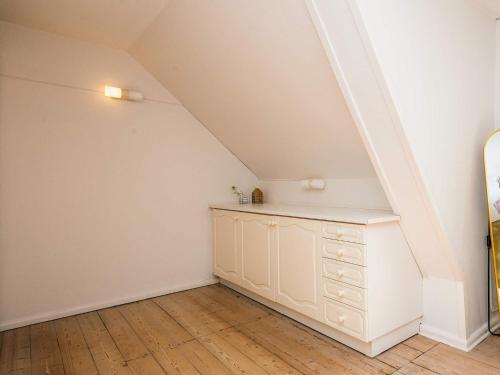 a room with a white dresser in a attic at 4 star holiday home in Nørre Nebel in Nørre Nebel