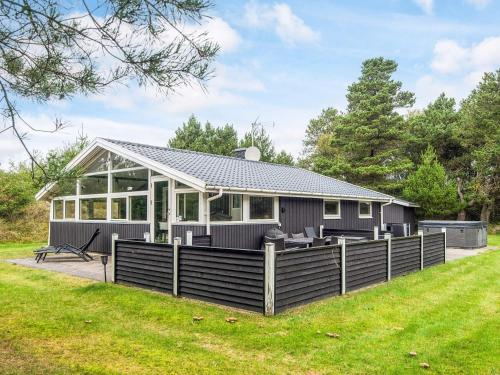 a modular home with a deck and a house at 6 person holiday home in Blåvand in Blåvand