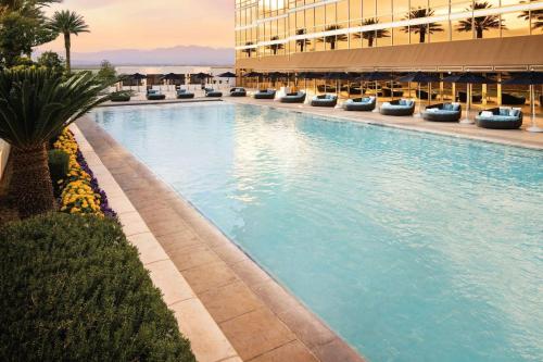 a large swimming pool in front of a building at Five Star Trump Hotel No Resort and Cleaning Fees in Las Vegas