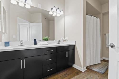 a bathroom with a sink and a large mirror at Spacious 3-Bedroom 3BTH Apt in Marina Del Rey! Pool, Hot Tub in Los Angeles