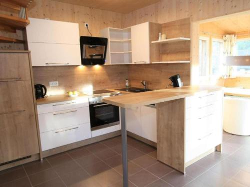 a kitchen with white cabinets and a wooden counter top at Heidi und Peter in Hohentauern