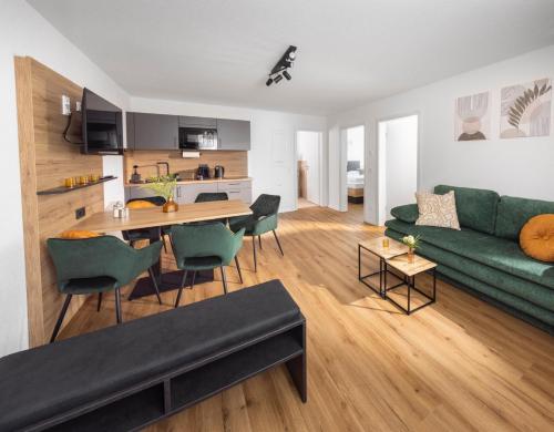a living room with a green couch and a table at Be Grand Apartments Rust in Rust