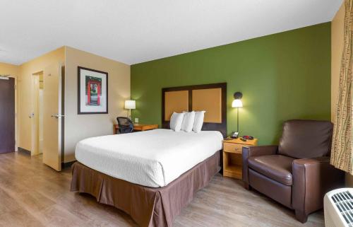 a hotel room with a bed and a chair at Extended Stay America Suites - Columbia - Laurel - Ft Meade in Jessup