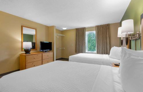 a hotel room with two beds and a television at Extended Stay America Suites - Columbia - Laurel - Ft Meade in Jessup
