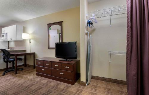 a room with a desk and a television on a dresser at Extended Stay America Suites - Indianapolis - Castleton in Fishers