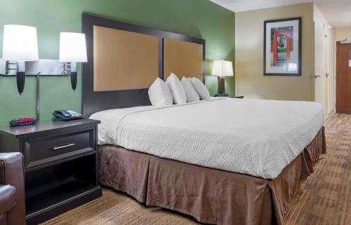 a large bed in a hotel room with a bed sidx sidx sidx at Extended Stay America Suites - Indianapolis - Castleton in Fishers