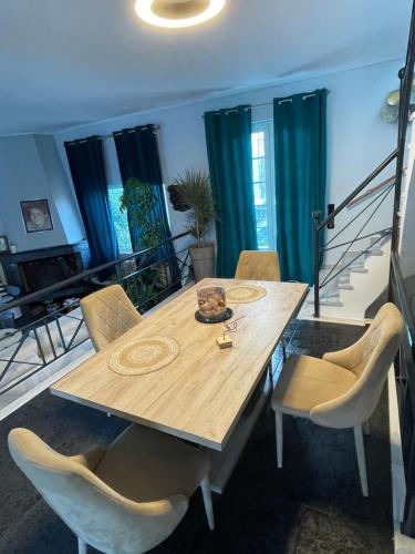 a dining room with a wooden table and chairs at Thiseos Georgia's Private Paradise in Lékhaion