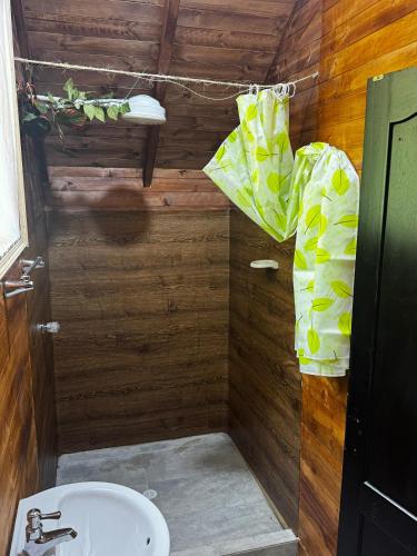 a small bathroom with a toilet and a sink at Cabañas del bosque - La casa en la piedra in Choachí