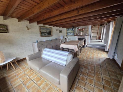 a living room with a couch and tables at Hof van Lapscheure in Damme