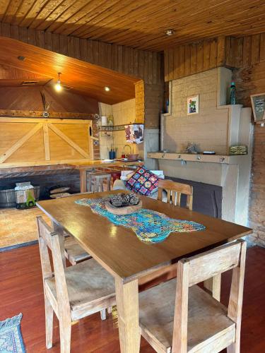 a dining room with a wooden table and chairs at Cabaña Muyal in Coihaique