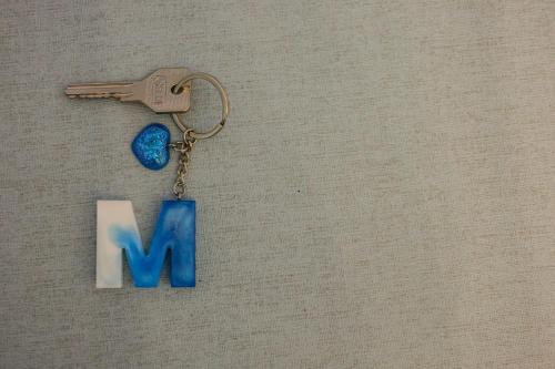 a key chain with a letter m and a gun at Mare Magnum in Castellammare di Stabia