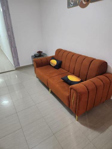 a large brown couch sitting in a room at Ramo in Dakar